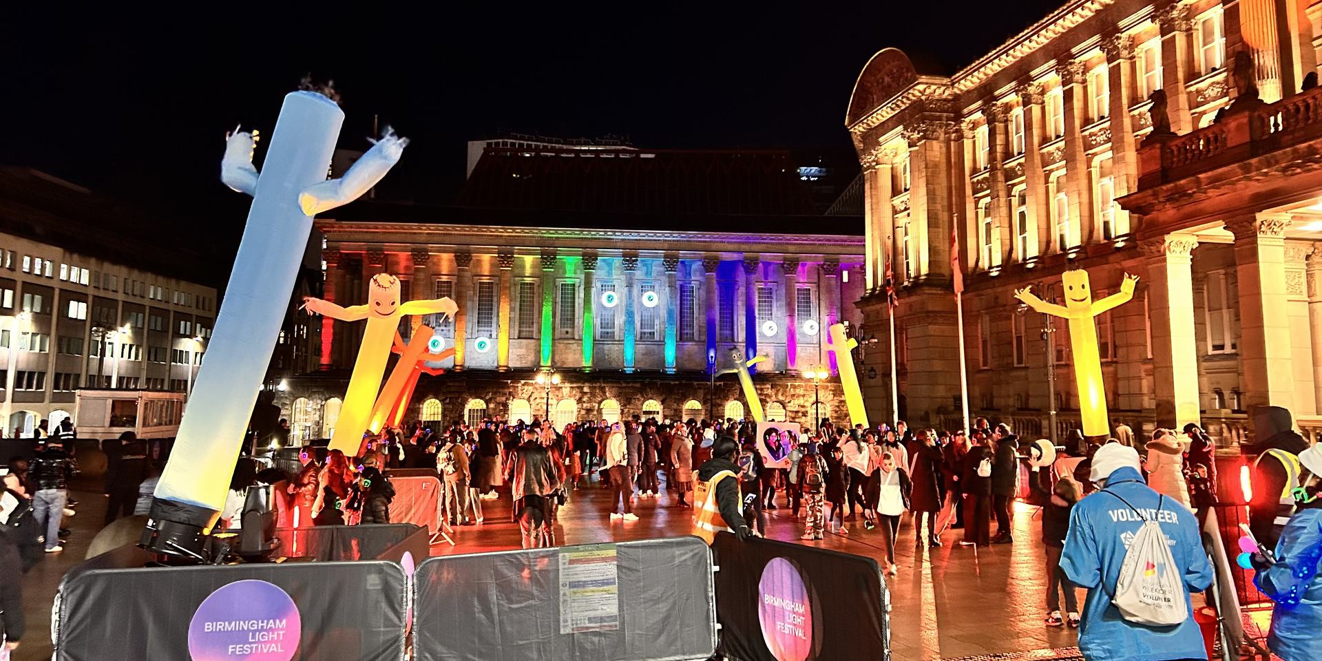 Evening crowds and inflatable figures at Birmingham Light Festival