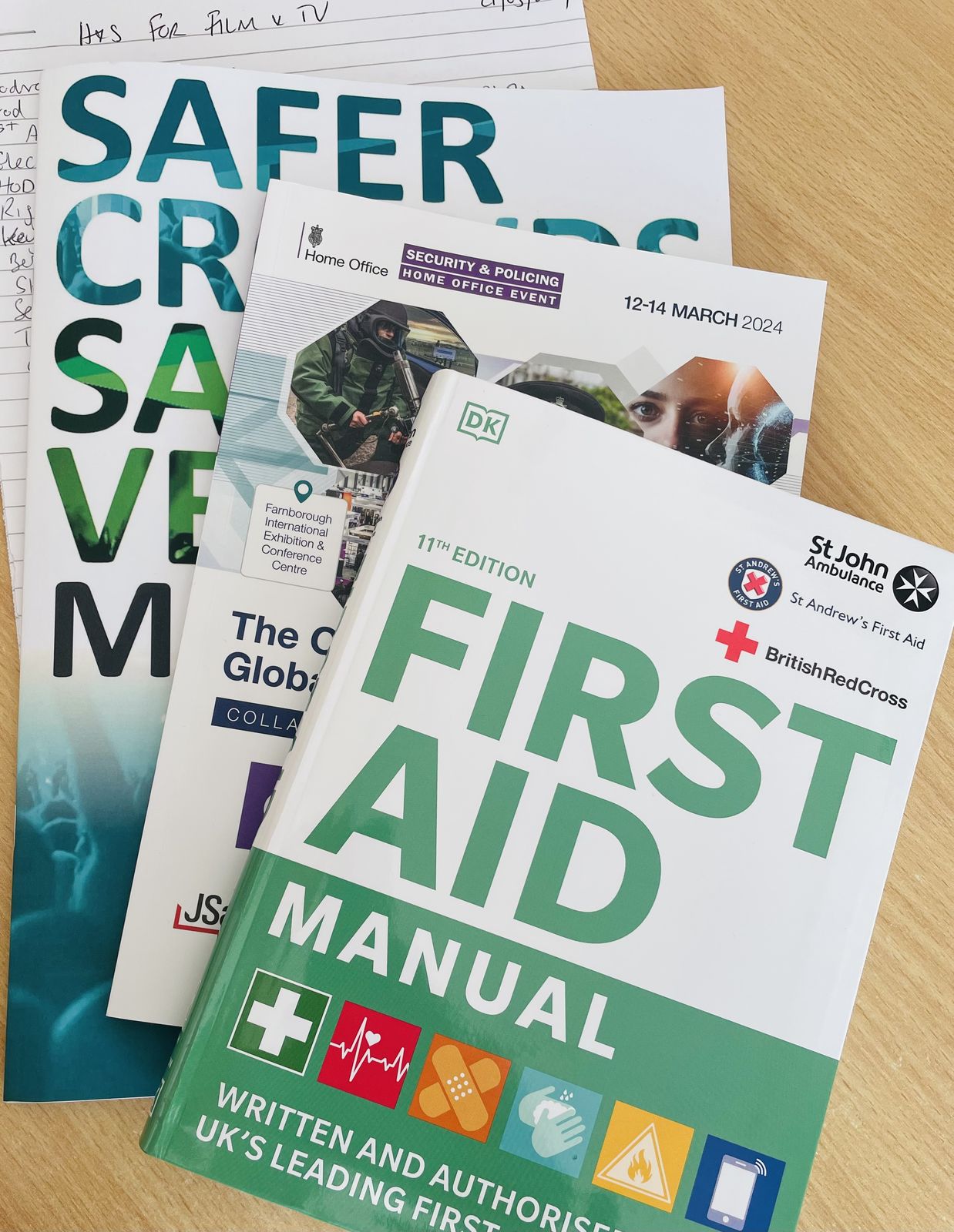 Conference programmes for Safer Crowds, Safer Venues and Security & Policing, with a first aid manual