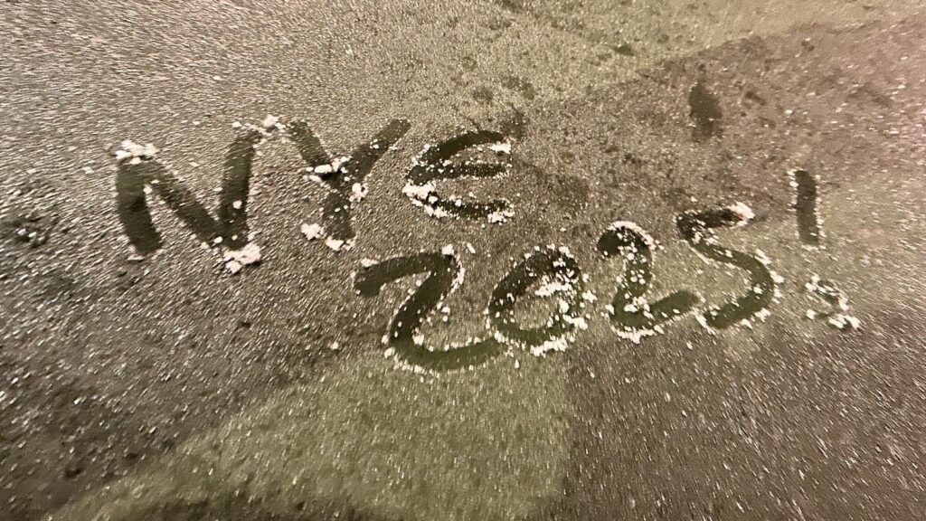 “NYE 2025!” written on the ground