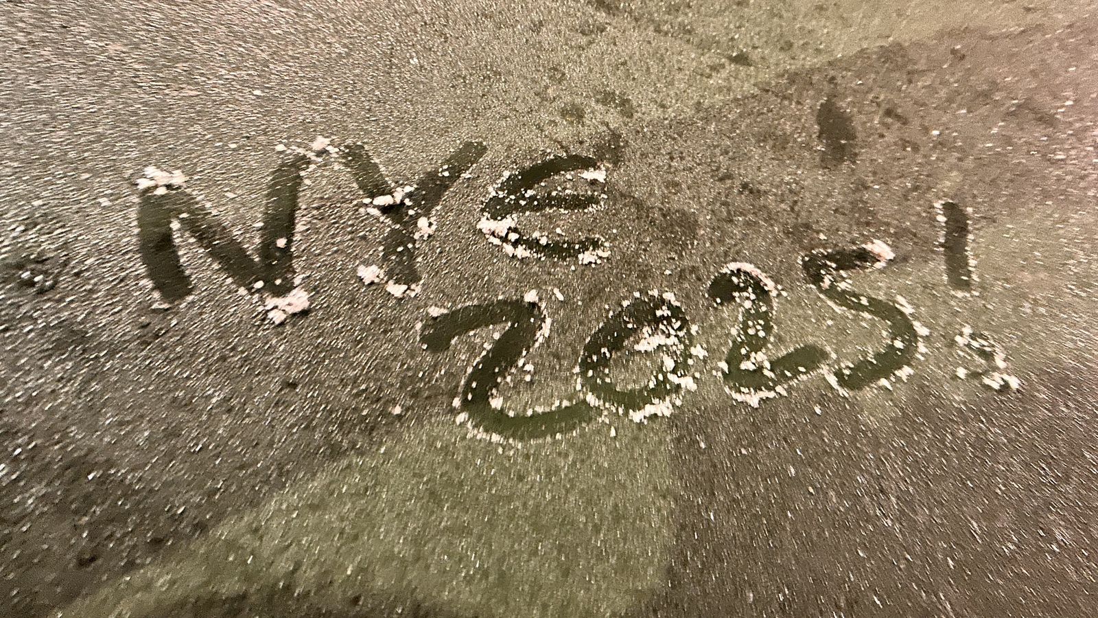 “NYE 2025!” written on the ground